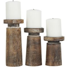 three wooden candle holders with white candles in them