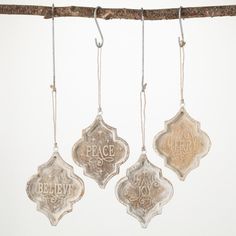 three ornaments hanging from a tree branch with the words peace and joy written on them