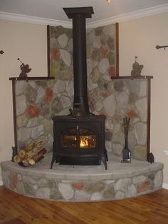 an image of a fire place in the middle of a room with rocks on it