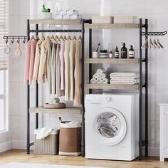 a washer and dryer in a room with clothes hanging on the rack next to it