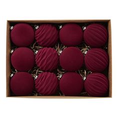 twelve red macaroons in a box on a white background with clippings