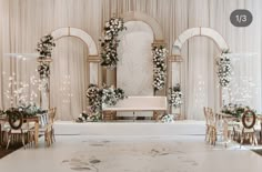 an elegant wedding setup with white flowers and greenery