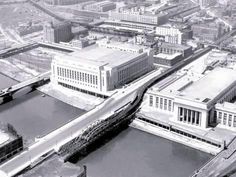 black and white photo of an aerial view of buildings in the city with water running through them