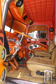 the interior of an orange truck with leather seats