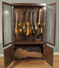 an open wooden case with guitars in it