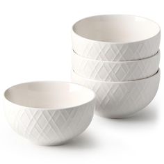 four white bowls stacked on top of each other