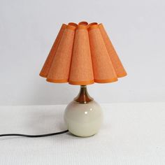 a lamp that is on top of a table with a cord attached to the base