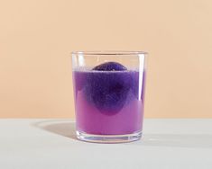 a purple substance in a glass on a table