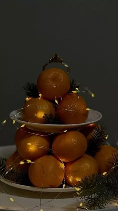 a plate with oranges on it and some lights around the edge, in front of a dark background