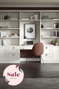 a desk with a laptop on top of it in front of some bookshelves