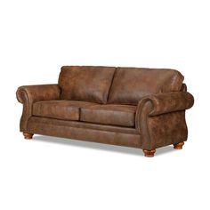 a brown leather couch sitting on top of a white floor