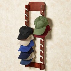 three hats are hanging on a wooden rack