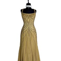 a dress on a mannequin with beading and sequins in gold