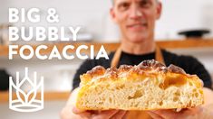 a man holding a piece of food in his hands with the words, big & bubbly focaccia