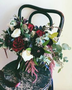 a bouquet of flowers sitting on top of a chair