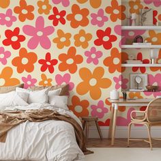 a bed sitting next to a wall covered in flowers