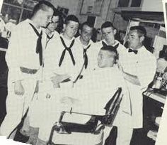 a group of men in white shirts and ties standing next to each other at a barbershop