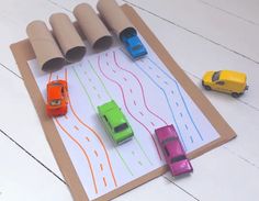 toy cars are lined up on a paper road