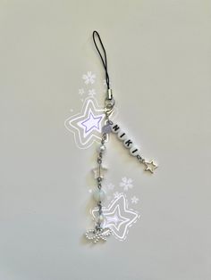 a keychain with stars and beads hanging from it's side on a table