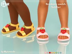 two pairs of children's sandals with strawberries on the toe and bottom, standing next to each other