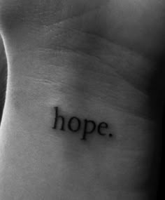 a small wrist tattoo with the word hope on it's left side ribcage