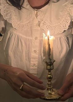 a woman holding a candle in her hands