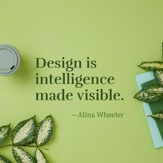 a green wall with a quote on it next to some leaves and a cup that says design is intelligente made visible