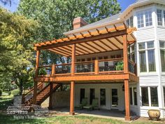 a large white house with a wooden deck