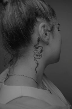 a woman with a snake tattoo on her neck