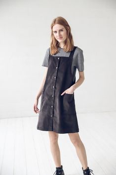 "DETAILS: * With two front pockets and buttons at full dress length * Short small apron dress suitable for all seasons * Made from 100 % cotton * Height of the model is 177 cm (5' 8\") and she is wearing size XS * The full dress length is 93 cm / 36.6'' * Color - black * Available in 2 colors. Please choose another color and size on the right * Product number: D16 CARE LABEL: * machine wash gentle (40 C/104 F) * dry gentle on low heat * wrinkles give the character so there is no need to iron, bu Cotton Workwear Apron With Pockets, Casual Cotton Apron With Pockets, Sleeveless Cotton Apron With Pockets, Cotton Apron With Pockets, Casual Cotton Pinafore Dress With Bib Front, Casual Bib Front Dress With Pockets, Brown Cotton Dress With Pockets, Brown Cotton Dresses With Pockets, Fall Cotton Dresses With Side Pockets