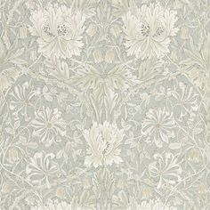 an ornate wallpaper with white flowers and leaves on it's side, in grey tones