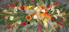 an arrangement of flowers and greenery in a vase