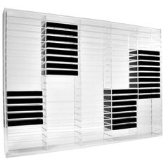 a white wall mounted air conditioner with black shutters