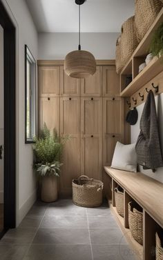 a hallway with wooden shelves and baskets on the wall, along with potted plants