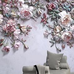 a living room filled with furniture and a wall covered in pink flowers on top of it