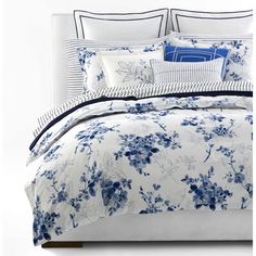 a bed with blue and white flowers on it