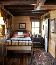 a bedroom with wood paneling and wooden floors