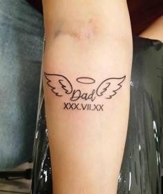 a person with a tattoo on their arm that says dad xxxviiixx