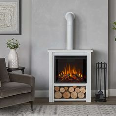 a living room with a couch and a fire place in the corner, next to a chair