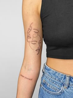 a woman's arm with a small tattoo on the left side of her body