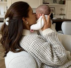 a woman holding a baby in her arms