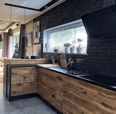 a kitchen with wooden cabinets and black counter tops, along with an open floor plan