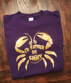 a purple t - shirt with gold foil on it that says i'd rather be shiny