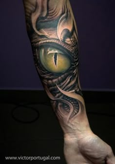 a man's leg with an eye tattoo on it