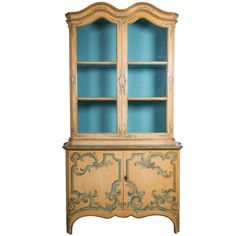 an old china cabinet with blue glass doors