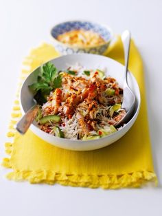 two bowls filled with food on top of a yellow cloth