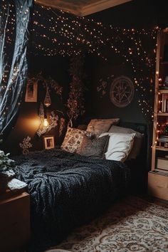 a bedroom decorated in black and white with fairy lights