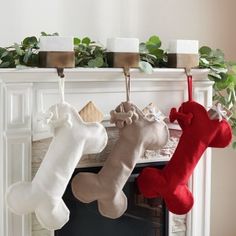 three stockings hanging from a fireplace mantel