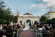 a bride and groom standing at the end of their wedding ceremony