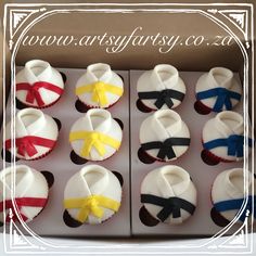 cupcakes decorated with bows and ribbons in a box